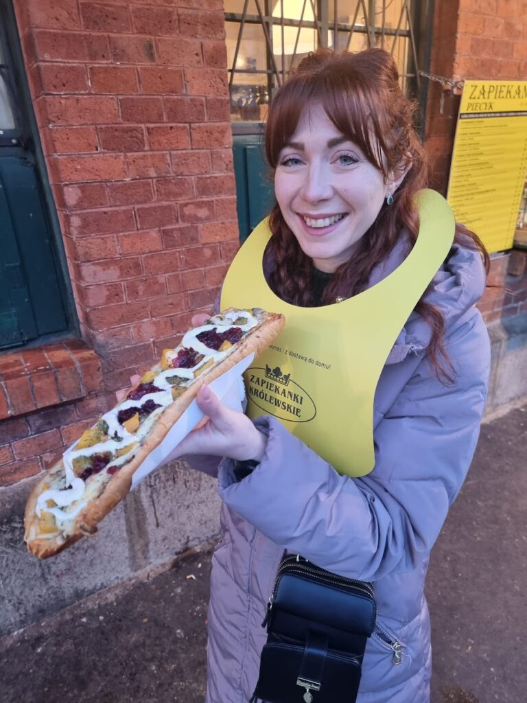 A photo of me eating a Zapiekanka.