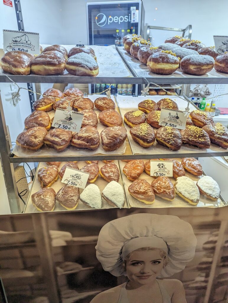 A storefront showing lots of Polish baked goods.