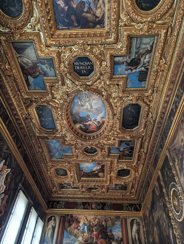 A ceiling features frescoes inside the Palace