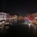 A photo of Venice's grand canal at night.