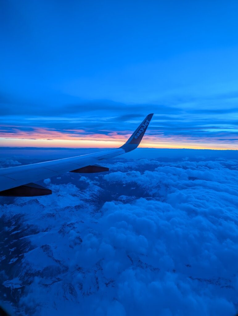 A plane soaring above the clouds