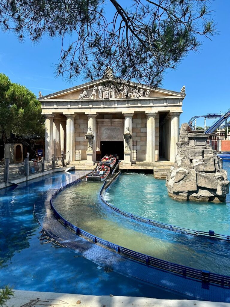 A water rollercoaster outside of a Greek temple